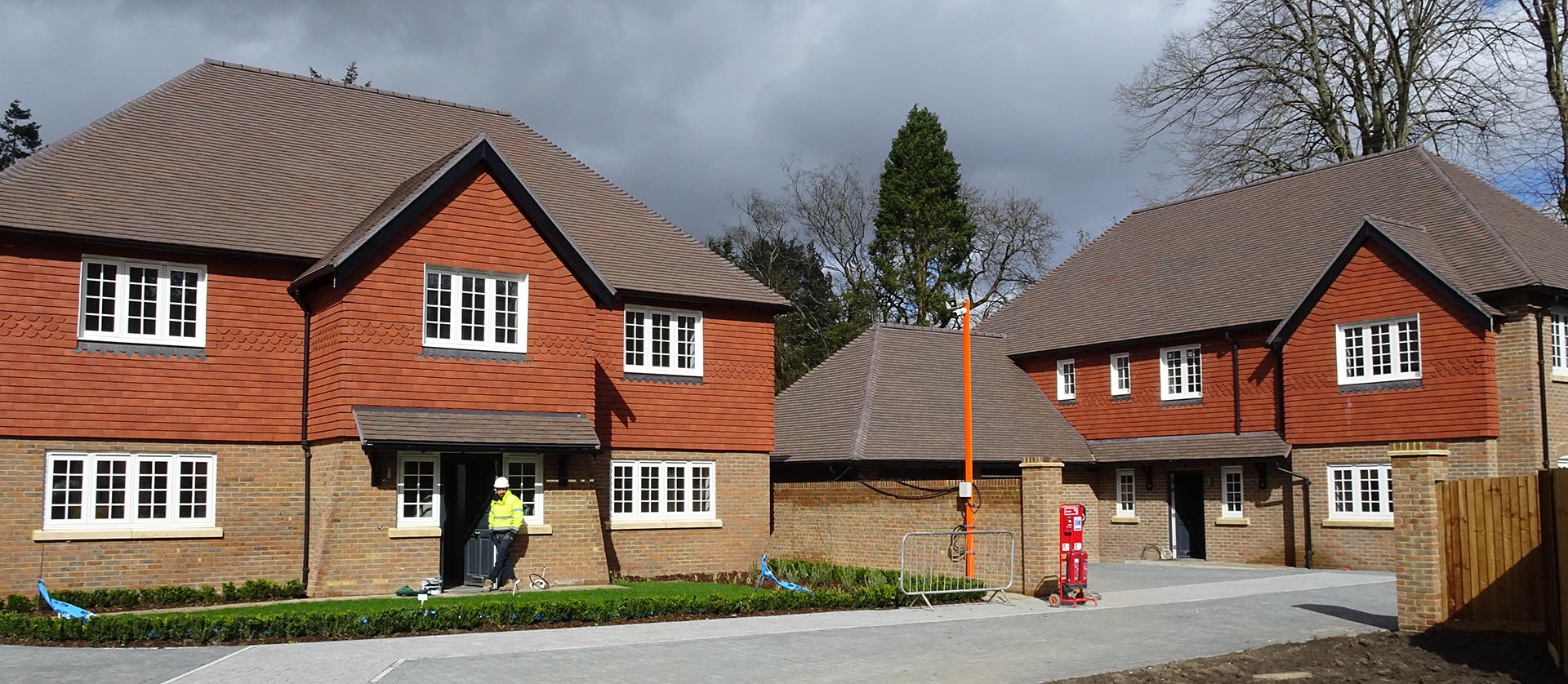 brown heather and red rustic vertical tiles at Merston Manor by Elivia Homes